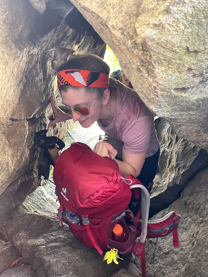 Crouching through the boulder cave